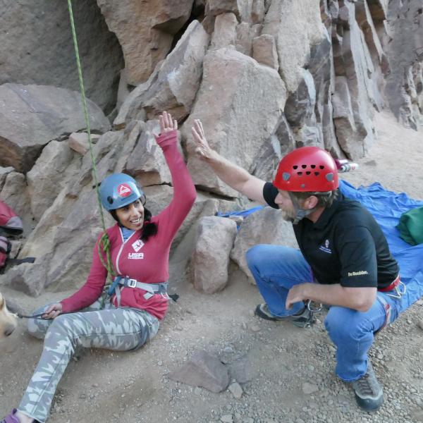 University of Colorado senior psychology major Esha Mehta gets a high five from Mike McNeil, Disability Access Coordinator at CU Boulder, while rock climbing in Eldorado Canyon. Mehta is a blind competitive rock climber.