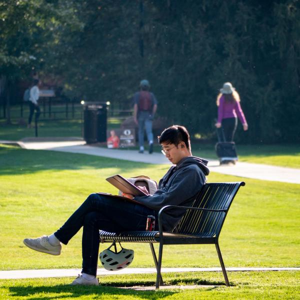 Students enjoy a warm fall day in the Norlin Quad. (Photo by Glenn Asakawa/University of Colorado)