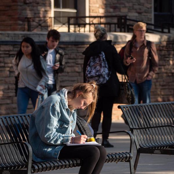 Students enjoy a warm fall day in the Norlin Quad. (Photo by Glenn Asakawa/University of Colorado)