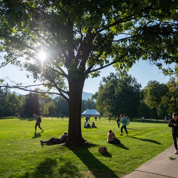 Students enjoy a warm fall day in the Norlin Quad. (Photo by Glenn Asakawa/University of Colorado)