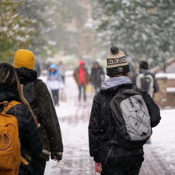 Students make their way to class during the first snowfall of the year on Oct. 10, 2019. (Photo by Patrick Campbell/University of Colorado)