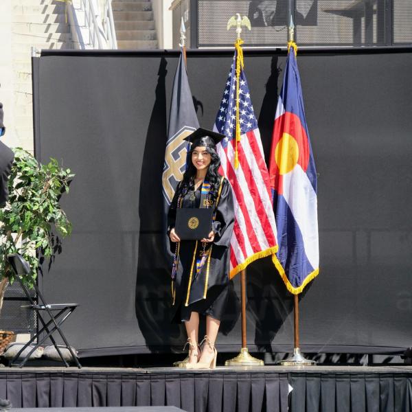 Graduates get their photo taken at Folsom Field during CU Boulder’s Graduate Appreciation Days events on April 23, 2021. (Photo by Glenn Asakawa/University of Colorado)