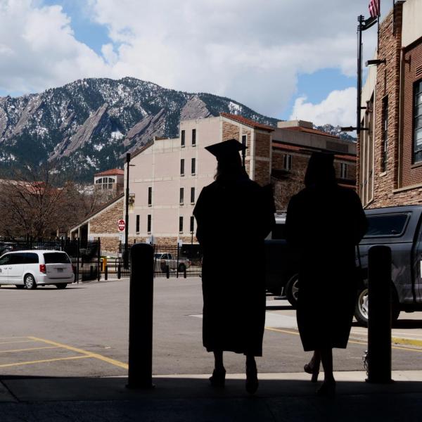 Graduates emerge from Folsom Field’s concourse after getting their formal portraits taken during CU Boulder’s Graduate Appreciation Days events. (Photo by Glenn Asakawa/University of Colorado)