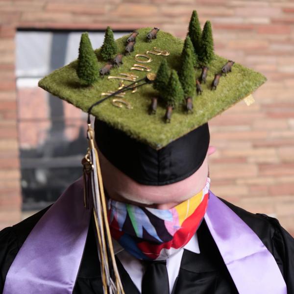 Aric McCarty sports a creatively decorated cap during CU Boulder’s Graduate Appreciation Days events. (Photo by Glenn Asakawa/University of Colorado)