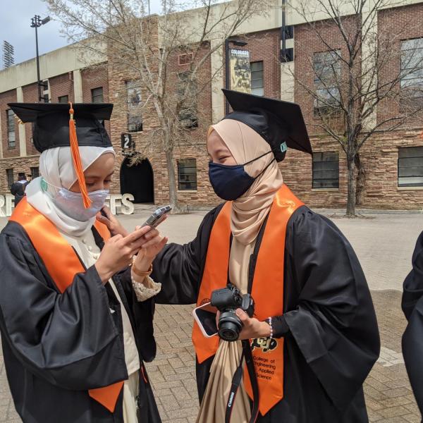 International chemical engineering graduates from Malaysia (from left) Nur Alwani, Nur SyrahHirah, and Adam Izz Khan finish a long distance chat with their families during CU Boulder’s Graduate Appreciation Days. (Photo by Glenn Asakawa/University of Colorado)