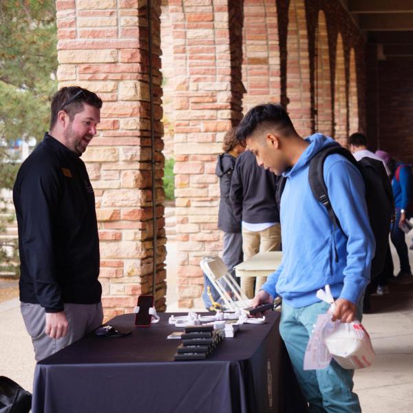 A student looks over a table at the Health Hut event near the UMC, part of the 2021 Health and Wellness Summit on the CU Boulder campus. (Photo by Glenn Asakawa/University of Colorado)