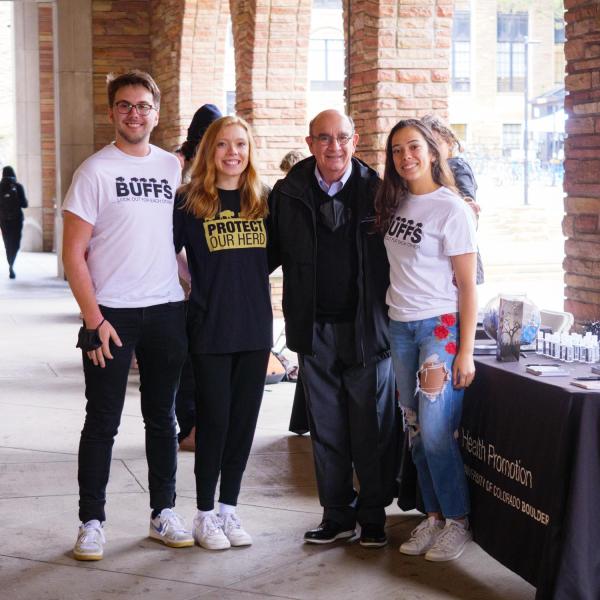 Chancellor Phil DiStefano poses with students staffing a table at the Health Hut event during the 2021 Health and Wellness Summit on the CU Boulder campus. (Photo by Glenn Asakawa/University of Colorado)