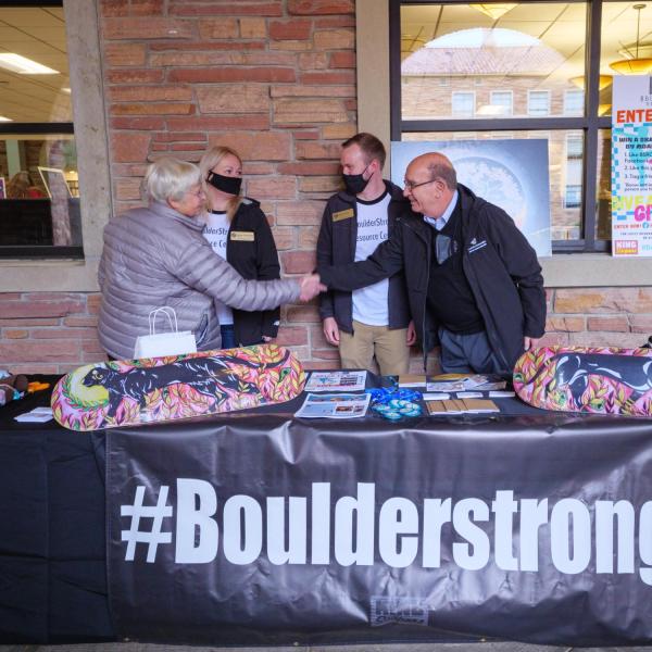 Chancellor Phil DiStefano, right, greets members of the #BoulderStrong Resource Center at the Health Hut during the 2021 Health and Wellness Summit on the CU Boulder campus. (Photo by Glenn Asakawa/University of Colorado)