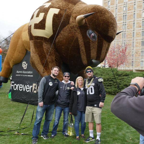 Homecoming game attendees pose for photo in front of inflatable Buffalo