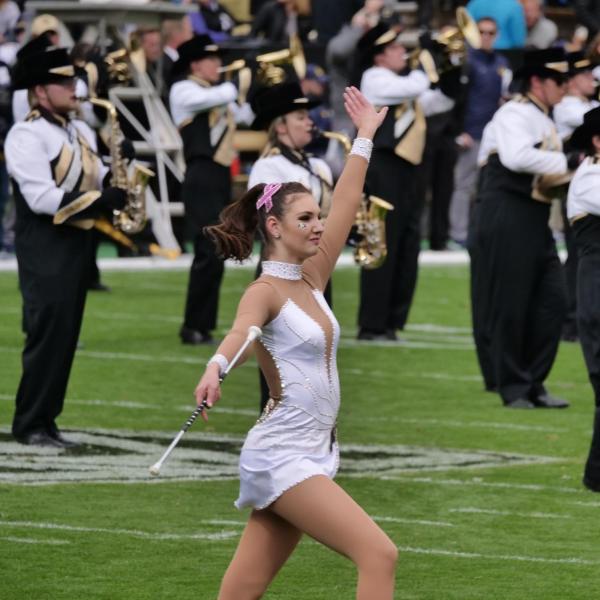 Baton twirler, marching band peform at halftime of the Homecoming game