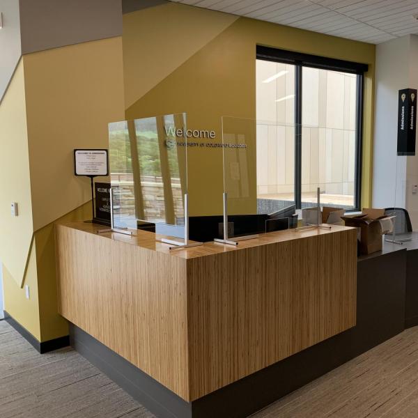 Protective measures, such as Plexiglas, are installed at customer service points on campus.