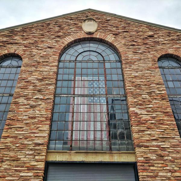 The American flag hangs in the north-facing window of Balch Fieldhouse. Photo by Patrick Campbell.