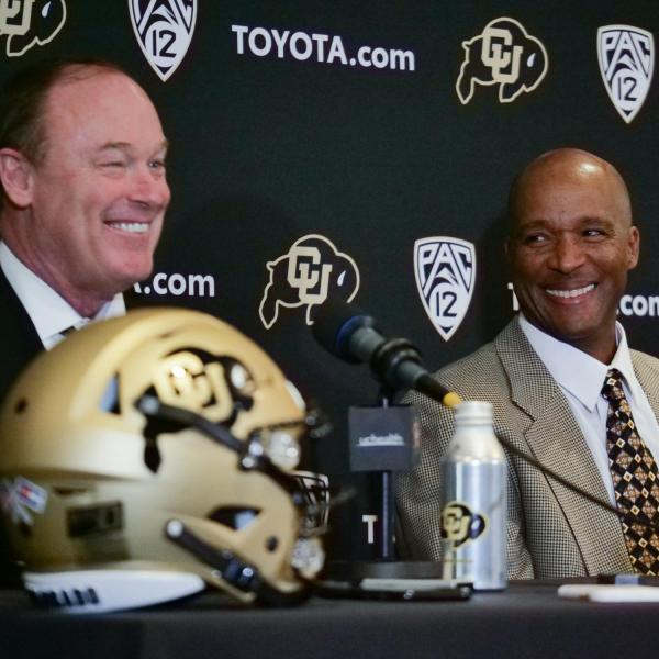 Athletic Director Rick George, left, and Karl Dorrell smile during a press conference announcing Dorrell as the new head football coach at CU Boulder. (Photo by Casey A. Cass/University of Colorado)