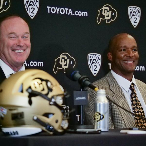 Athletic Director Rick George, left, and Karl Dorrell smile during a press conference announcing Dorrell as the new head football coach at CU Boulder. (Photo by Casey A. Cass/University of Colorado)