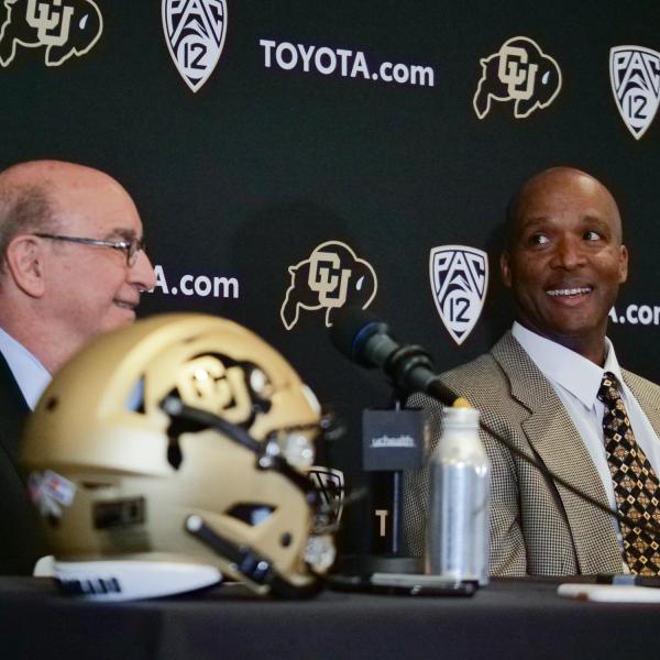 Chancellor Philip DiStefano, left, and Karl Dorrell smile during a press conference announcing Dorrell as the new head football coach at CU Boulder. (Photo by Casey A. Cass/University of Colorado)