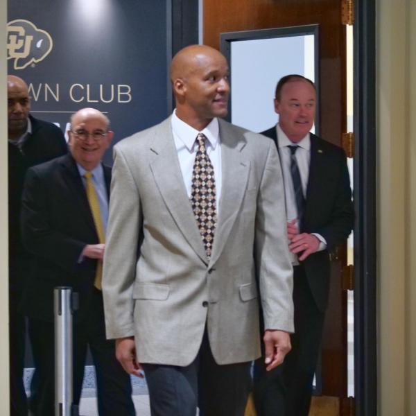 New CU football head coach Karl Dorrell, left, enters the Arrow Touchdown Club with Chancellor Phil DiStefano, center, and Athletic Director Rick George for his introductory press conference at the Dal Ward Center at Folsom Field. (Photo by Glenn Asakawa/University of Colorado)