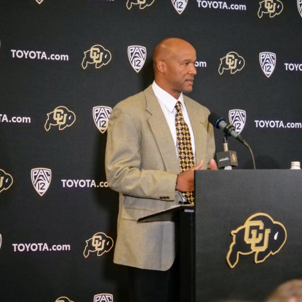 New CU football head coach Karl Dorrell, left, answers questions as Athletic Director Rick George listens at a press conference at the Dal Ward Center at Folsom Field. (Photo by Glenn Asakawa/University of Colorado)