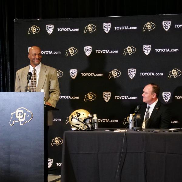 New CU football head coach Karl Dorrell, left, smiles with Athletic Director Rick George, center, and Chancellor Phil DiStefano during an introductory a press conference at the Dal Ward Center at Folsom Field. (Photo by Glenn Asakawa/University of Colorado)