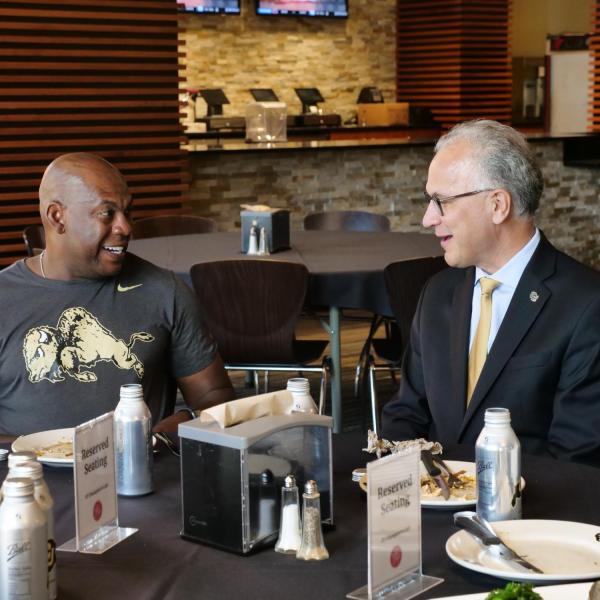 CU President Mark Kennedy, right, chats with CU Football Head Coach Mel Tucker during a tour of the athletics facilities. (Photo by Glenn Asakawa/University of Colorado)