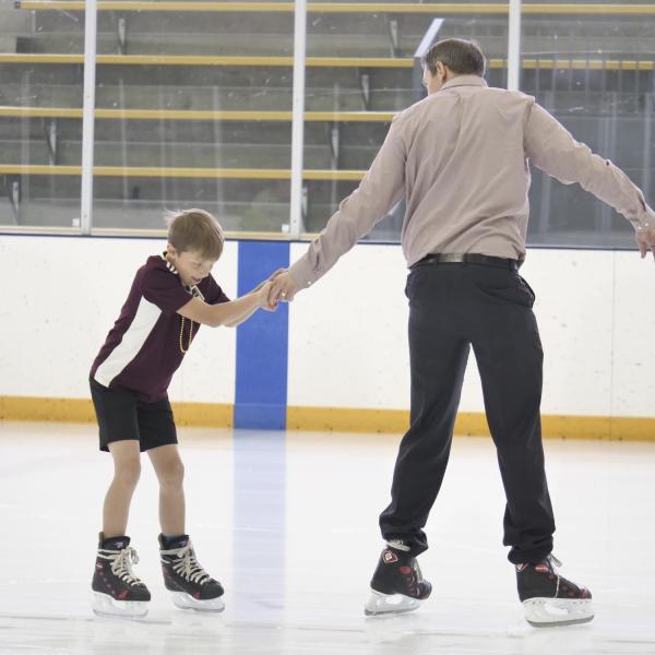 Getting a helping hand on the ice rink. (Photo by Casey A. Cass/University of Colorado)