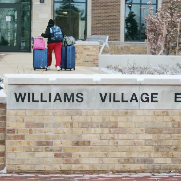 A student moves their belongings during Move-In Day on Feb. 8, 2021, at Williams Village at CU Boulder. (Photo by Casey A. Cass/University of Colorado)