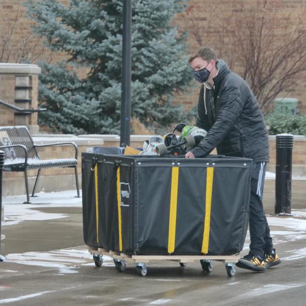 A student moves their belongings during Move-In Day on Feb. 8, 2021, at Williams Village at CU Boulder. (Photo by Casey A. Cass/University of Colorado)