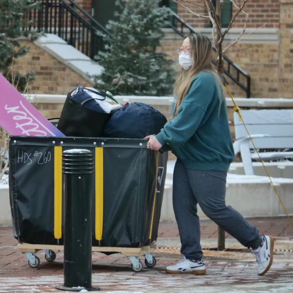 A student moves their belongings during Move-In Day on Feb. 8, 2021, at Williams Village at CU Boulder. (Photo by Casey A. Cass/University of Colorado)