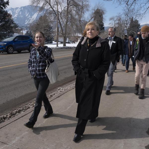 Jade Foxall, Environmental Board co-chair, left, visits with Angie Paccione during a sustainability tour at CU Boulder