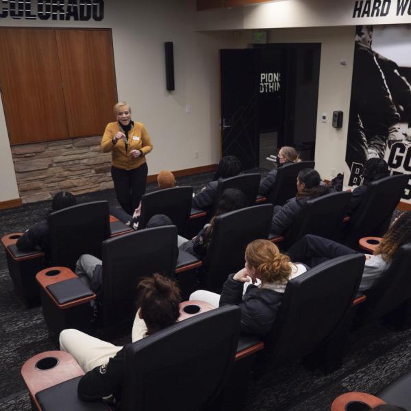 Angie Paccione speaks to members of the women’s basketball team during her visit