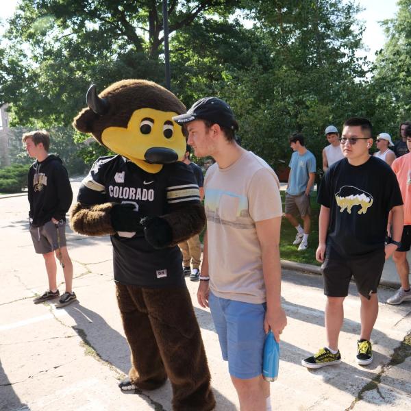 Chip entertains Program for Exploratory Studies students waiting for orientation at Macky Auditorium.(Photo by Glenn Asakawa/University of Colorado)