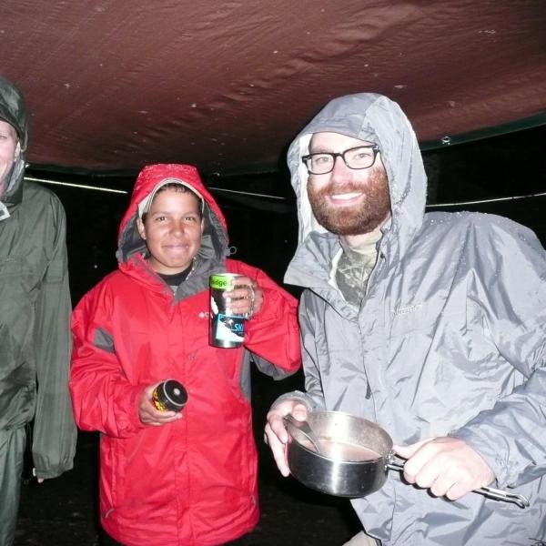 A CU Boulder field team hides out from the rain. (Credit: McCain Lab)