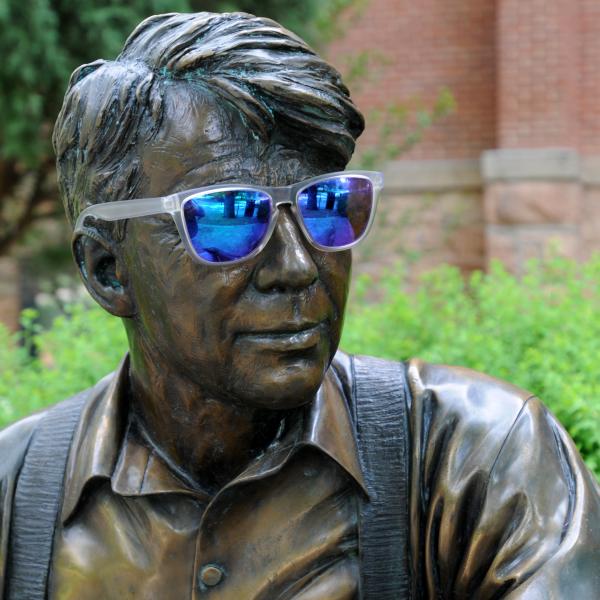 Campus statue of Robert Frost dons sunglasses on a hot day