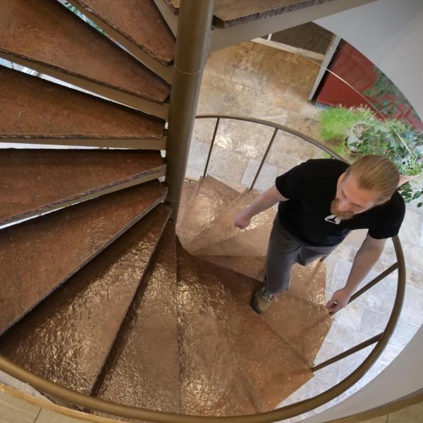 JILA graduate student and teaching assistant Cameron Straatsma climbs the spiral staircase in the JILA building. Photo by Casey A. Cass.