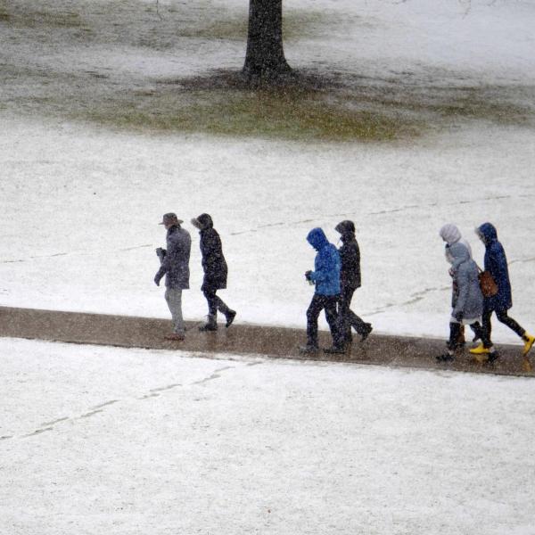 People walk across a snowy campus. Photo by Casey A. Cass.