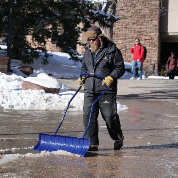 Facilities management works to clear snow around campus after a weekend snowstorm blanketed the campus with several inches of fresh snow. Photo by Casey A. Cass.