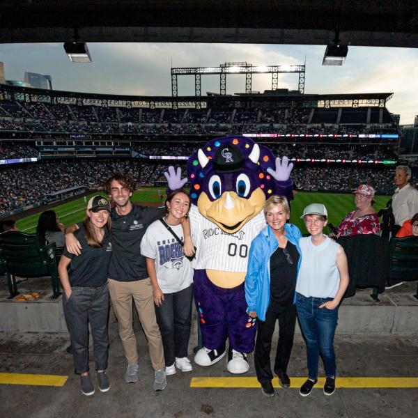 CU Boulder first-place international solar decathlon team members pose with U.S. Secretary of Energy Jennifer Granholm, second from right, and Colorado Rockies mascot Dinger during a game against the St. Louis Cardinals on July 1. The team was hosted and recognized by the secretary during her visit to Denver. (Photo courtesy of the Colorado Rockies)
