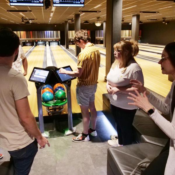 Strategic Resources and Support employees enjoy bowling at an appreciation event in The Connection