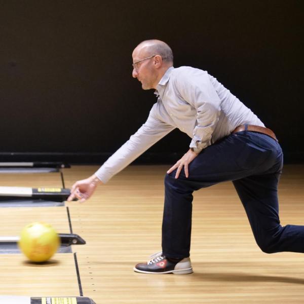 Strategic Resources and Support employees enjoy bowling at an appreciation event in The Connection