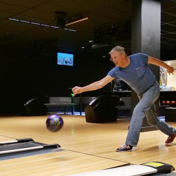 Strategic Resources and Support employees enjoy bowling at an appreciation event in The Connection
