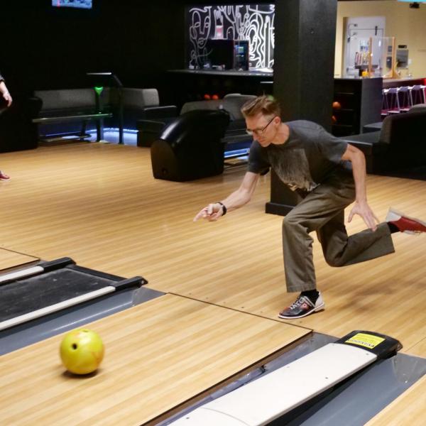Strategic Resources and Support employees enjoy bowling at an appreciation event in The Connection