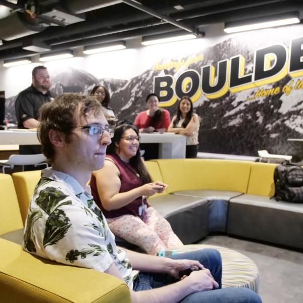 Strategic Resources and Support employees play video games at an appreciation event in The Connection