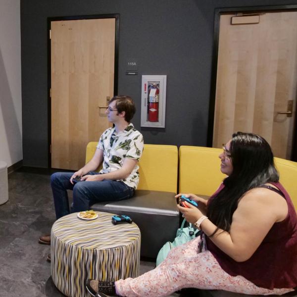 Strategic Resources and Support employees play video games at an appreciation event in The Connection