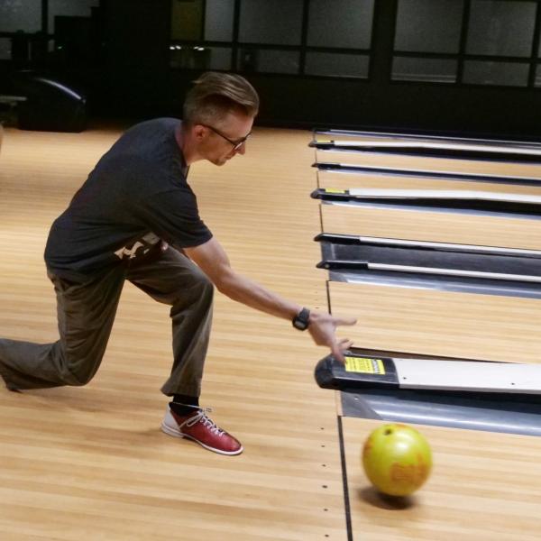 Strategic Resources and Support employees enjoy bowling at an appreciation event in The Connection