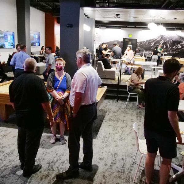 Strategic Resources and Support employees mingle at an appreciation event in The Connection