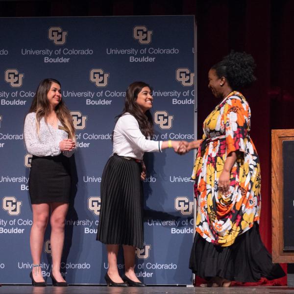 Tarana Burke is greeted on stage by Cultural Events Board representatives. Photo by Glenn Asakawa.