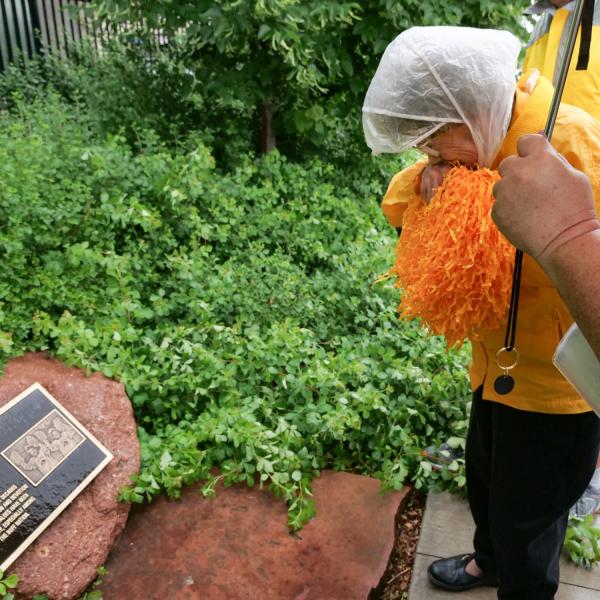 Peggy Coppom looks over a plaque honoring her and her late twin sister, Betty Hoover. (Photo by Glenn Asakawa/University of Colorado)