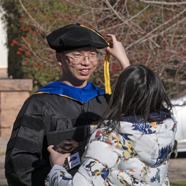 Graduates and families celebrating 2021 winter conferral. Photo by Casey A. Cass.