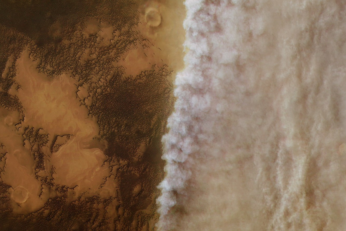 Satellite image of the surface of Mars. Left half of the image is clear, while the right half is clouded in dust