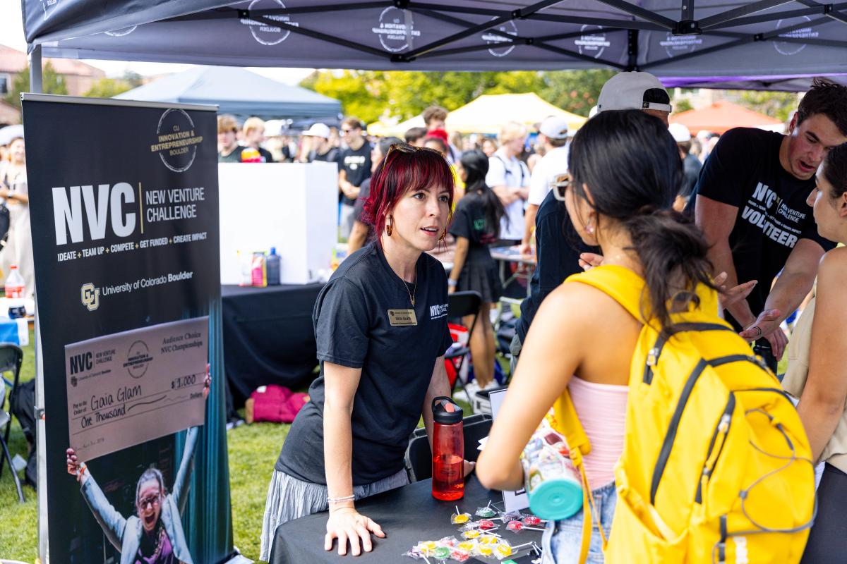 employee tabling at the Be Involved Fair