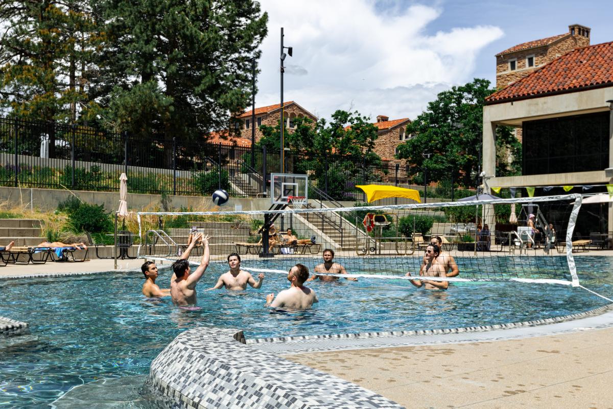 students playing volleyball in the Buff Pool on campus
